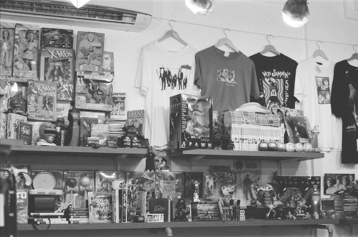 Shelves filled with pop culture merchandise and hanging shirts.