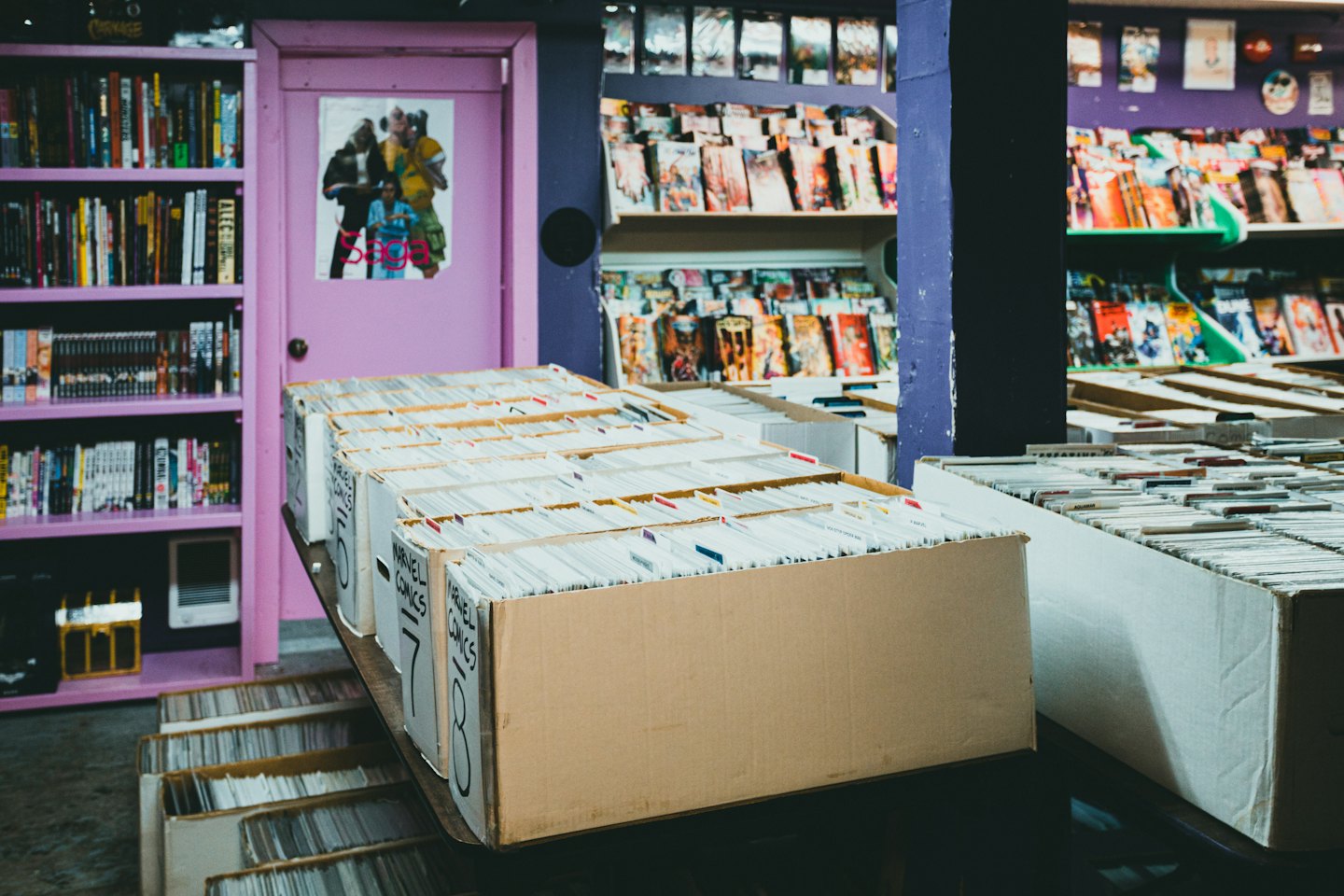 Comic books displayed on shelves and in storage boxes.
