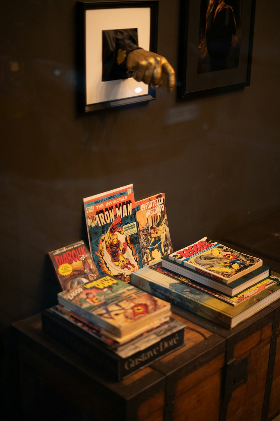 Vintage comic books rest on a rustic wooden chest.