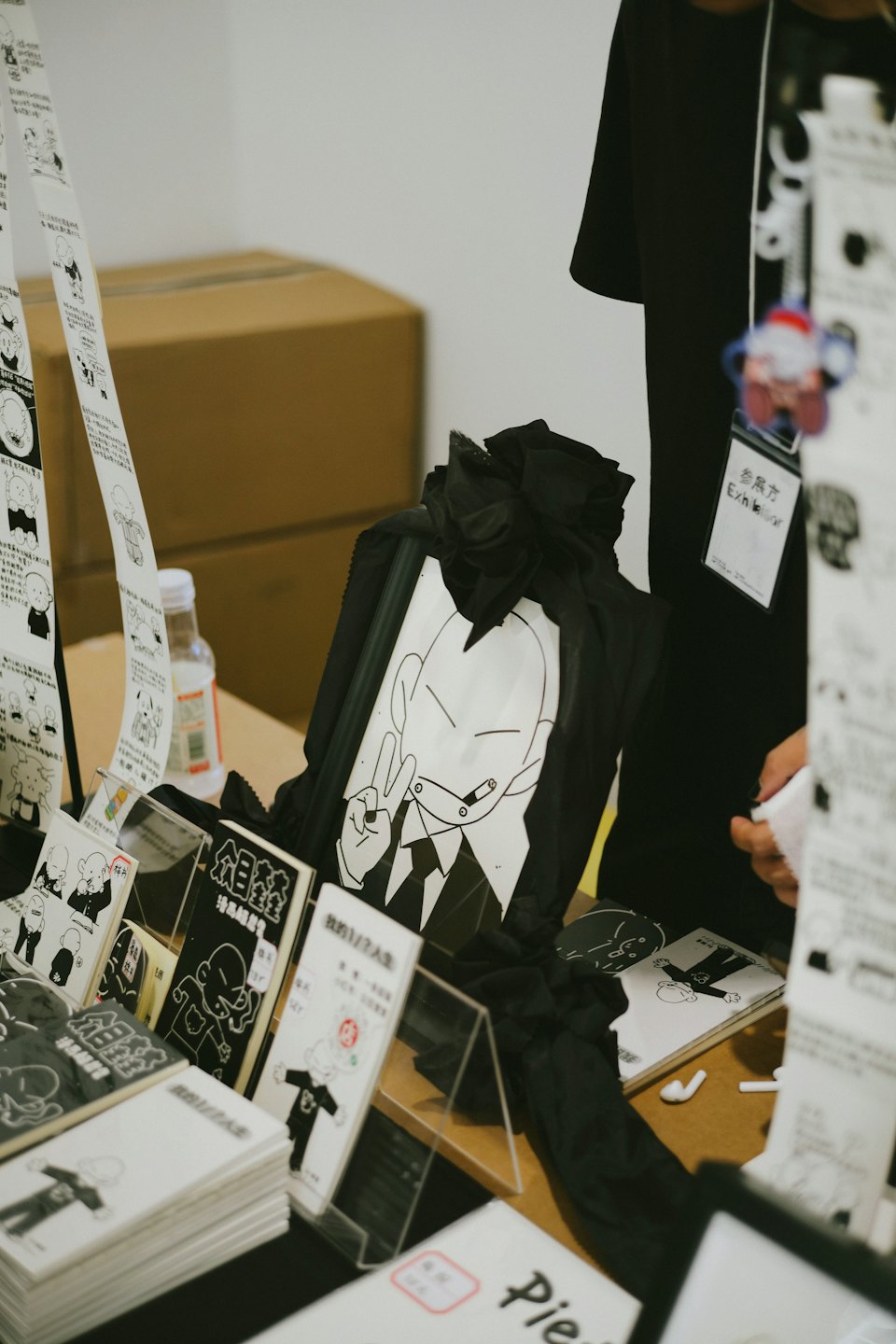 Display booth at an event with comic books and t-shirts.